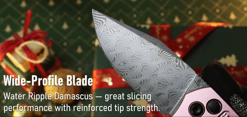 Knife with wide-profile blade and water ripple Damascus pattern against a festive background.