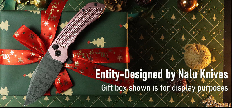 Folding knife on a wrapped gift box with a red ribbon, on a patterned surface.